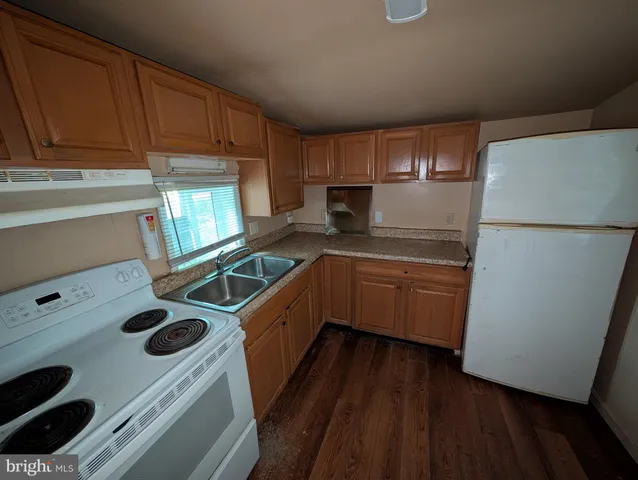 a kitchen with a stove a sink and a refrigerator