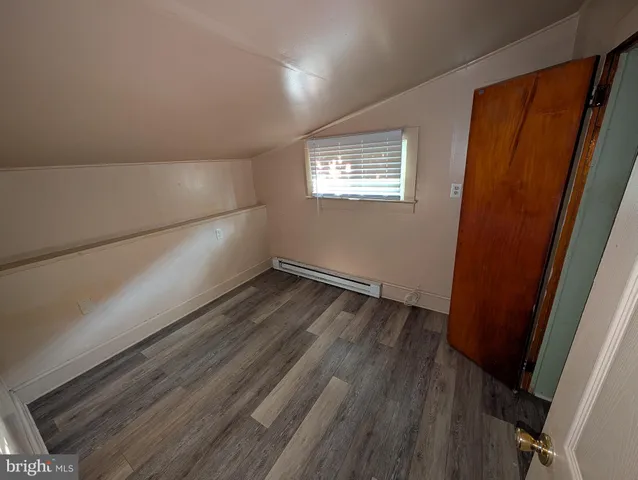a view of an empty room and wooden floor