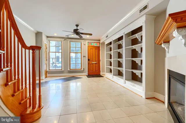 a view of an empty room with a fireplace and a window