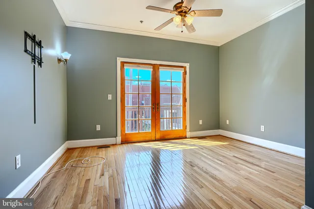 a view of an empty room with wooden floor
