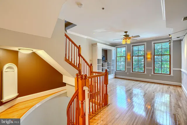 a view of entryway and hall with wooden floor