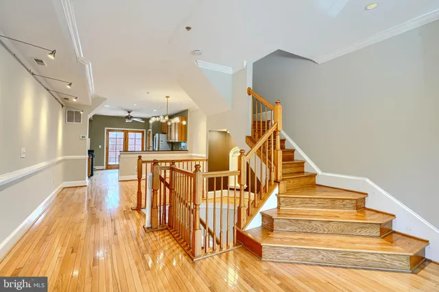 a view of entryway and hall with wooden floor