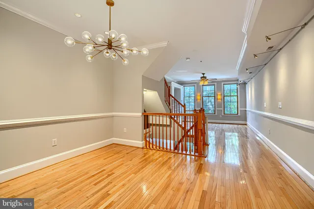 a view of a room with wooden floor fan and window