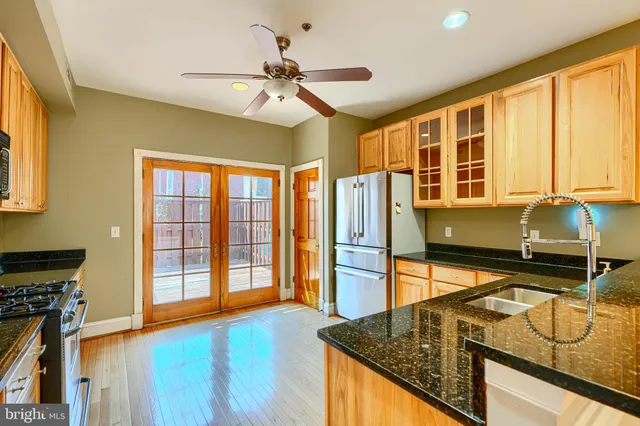 a kitchen with stainless steel appliances granite countertop a sink and a stove