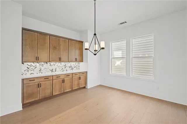 a kitchen with stainless steel appliances granite countertop a sink a stove and a window