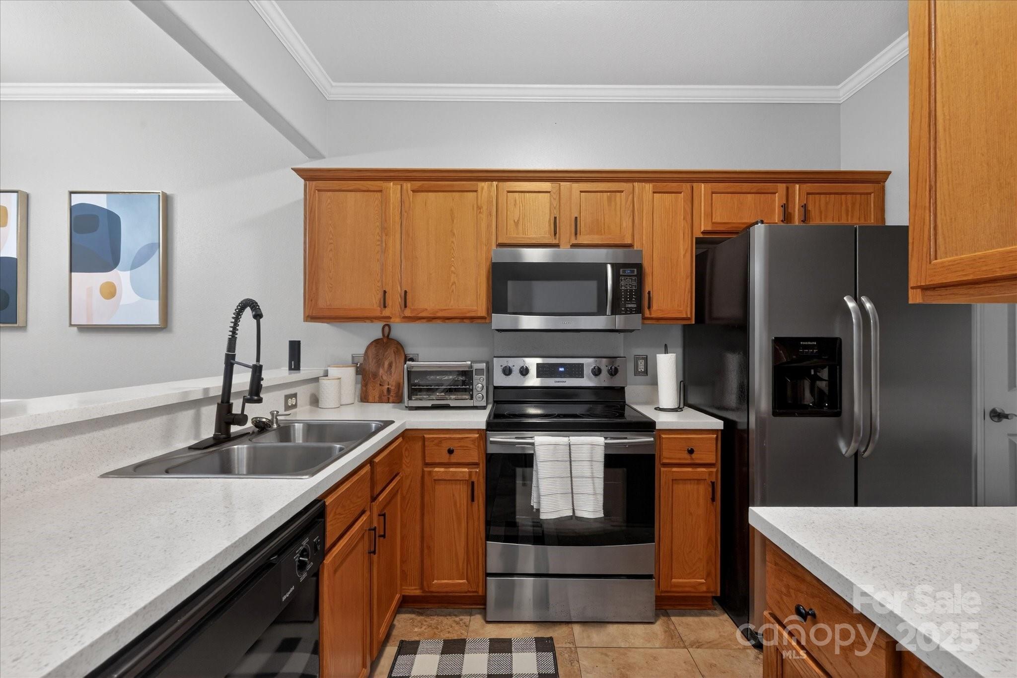 6331 Rhodins Lane Fort Mill, SC 29707 - Photo 11 of 45 a kitchen with stainless steel appliances granite countertop a sink stove microwave and refrigerator