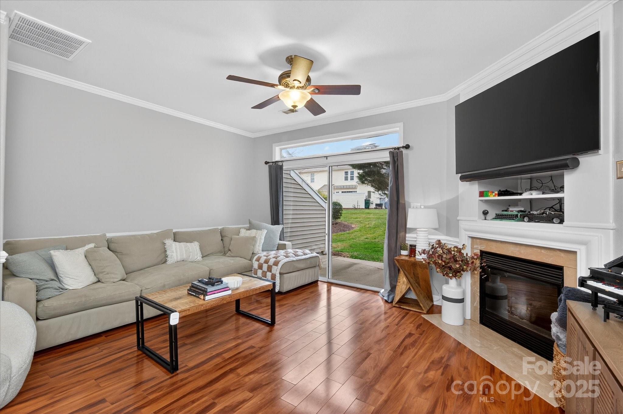 6331 Rhodins Lane Fort Mill, SC 29707 - Photo 8 of 45 a living room with furniture a fireplace and a flat screen tv