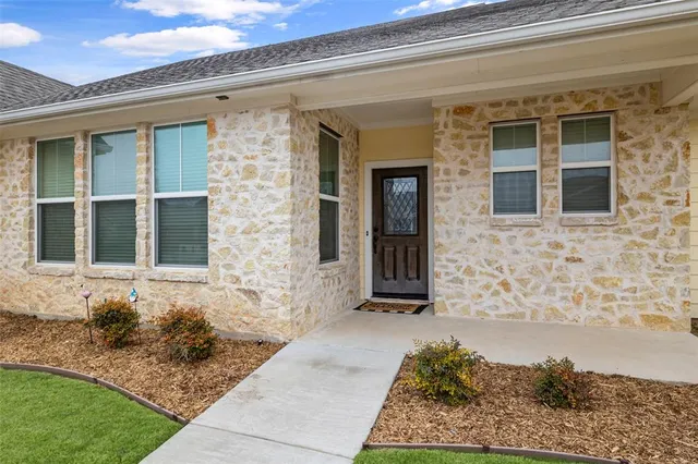 an empty room with fan and entrance