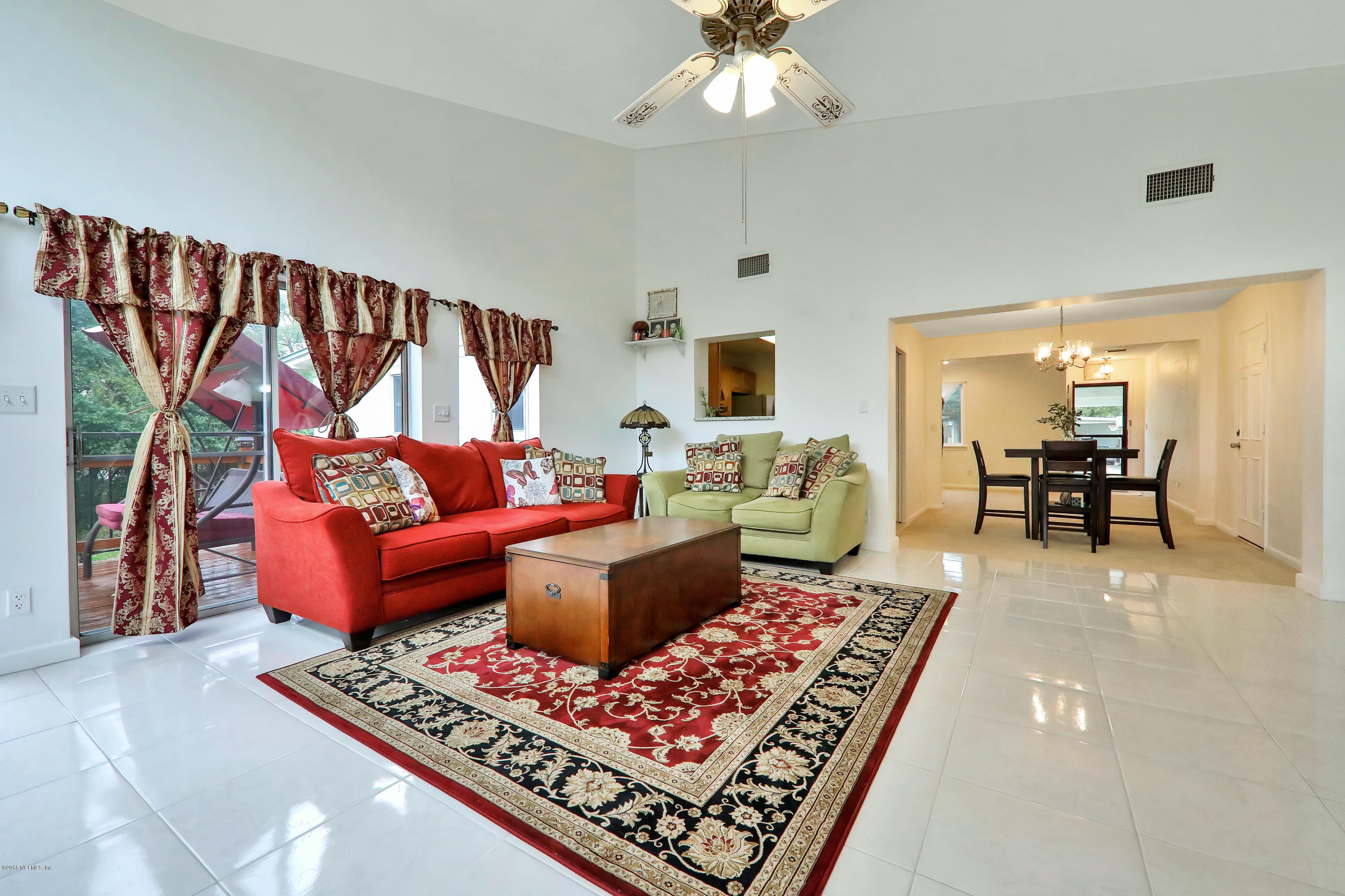 2519 Sam Road Jacksonville, FL 32216 - Photo 8 of 26 a living room with furniture a rug and a chandelier
