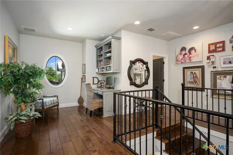 a view of a hallway with entryway wooden floor and front door
