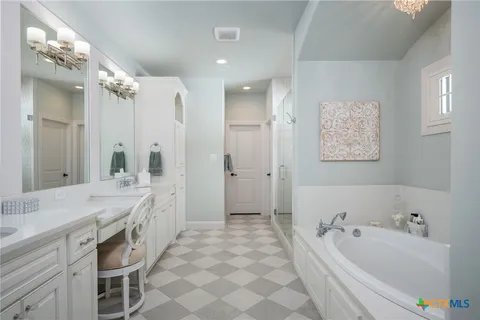 a spacious bathroom with a double vanity sink mirror and double