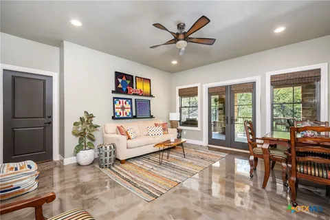 a living room with furniture a wooden floor and a chandelier