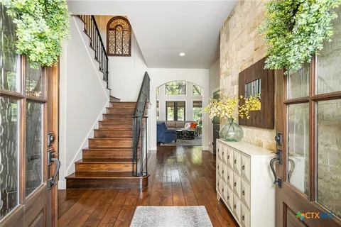 a view of an entryway with wooden floor