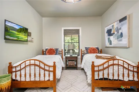a bedroom with two beds and a window