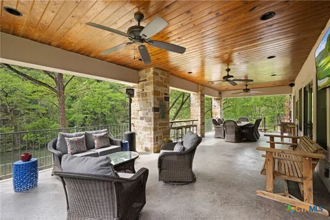 a living room with patio furniture and a potted plant