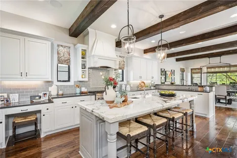 a kitchen with a table chairs stove and cabinets