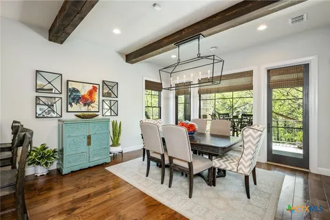 a dining room with furniture a rug and wooden floor