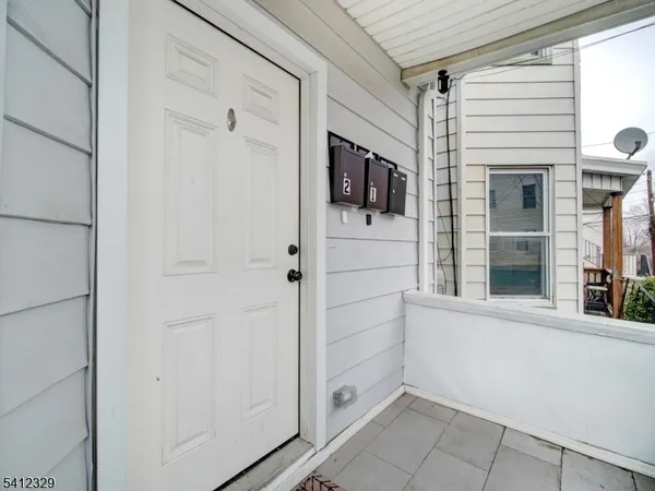 a view of kitchen with stainless steel appliances cabinets and window