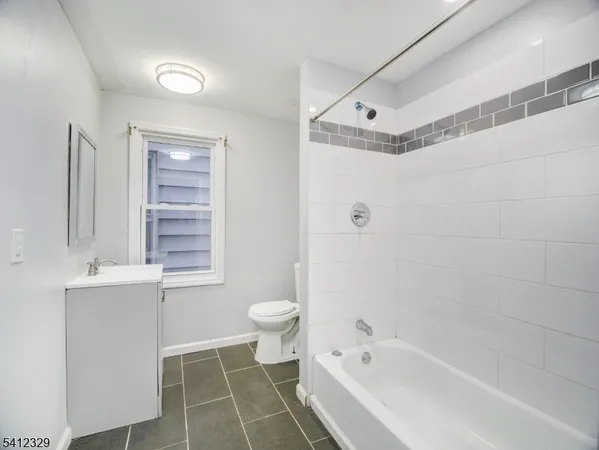 a bathroom with a bathtub toilet and sink