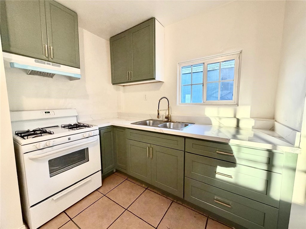 890 4th Street Pomona, CA 91766 - Photo 2 of 11 a kitchen with granite countertop a sink stainless steel appliances and cabinets