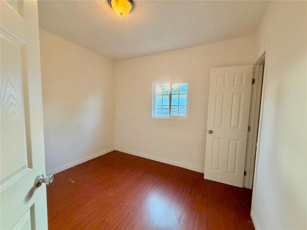 890 4th Street Pomona, CA 91766 - Photo 6 of 11 an empty room with wooden floor and windows