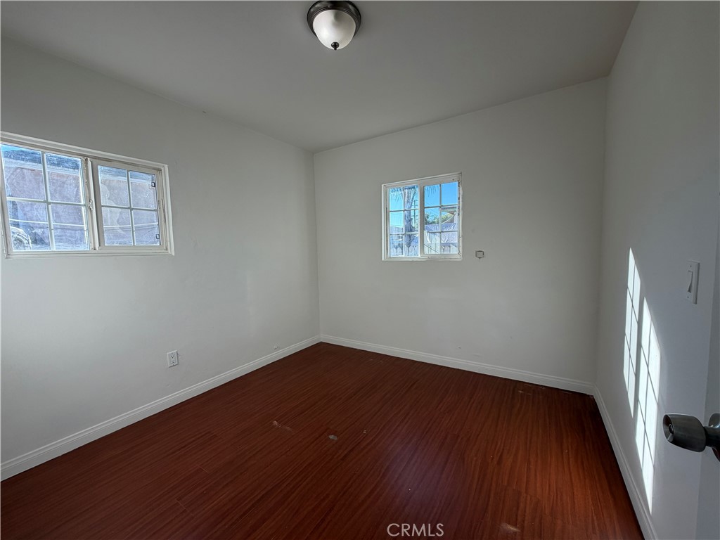 890 4th Street Pomona, CA 91766 - Photo 8 of 11 an empty room with wooden floor and windows