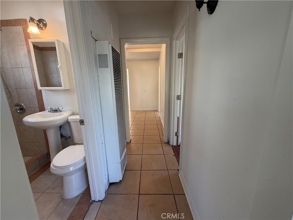 890 4th Street Pomona, CA 91766 - Photo 9 of 11 a bathroom with a toilet and a shower