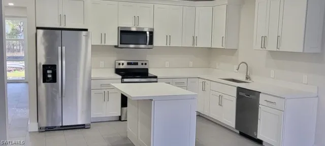 a kitchen with a sink a stove and refrigerator