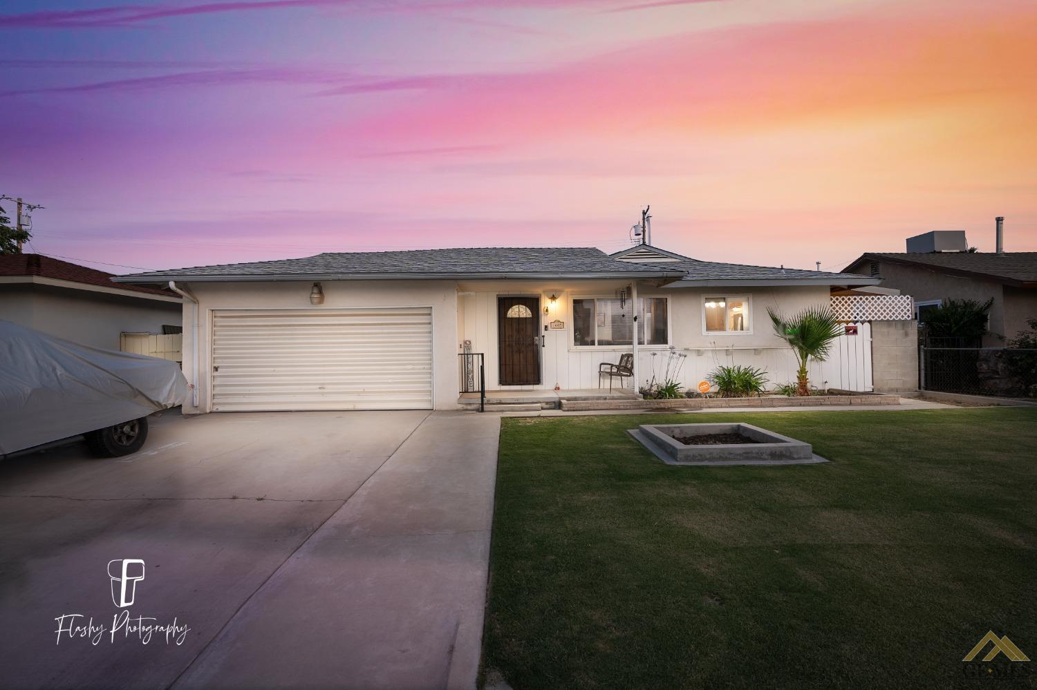 Undisclosed Address Bakersfield, CA 93304 - Photo 1 of 38 a front view of a house with a garden and yard