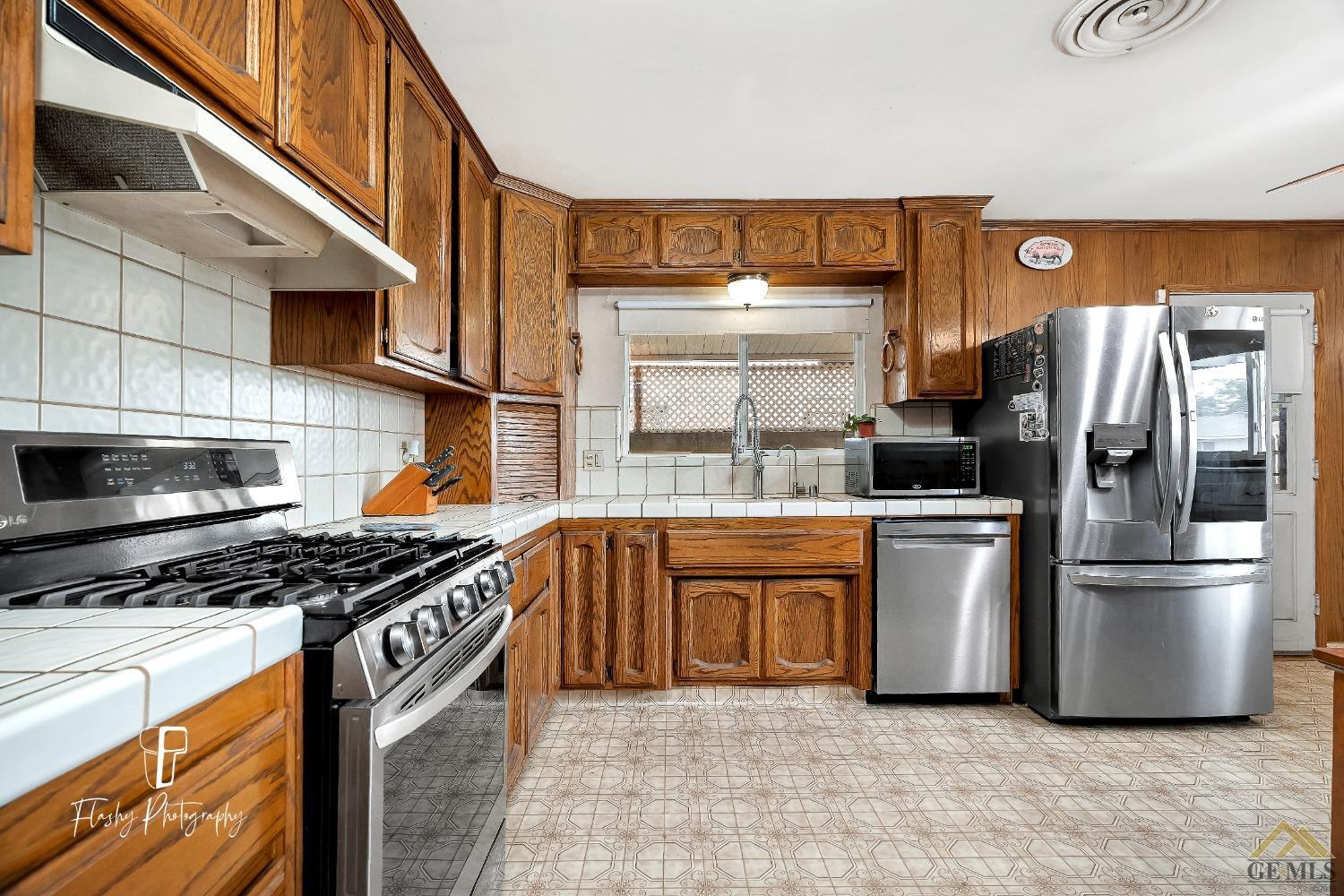 Undisclosed Address Bakersfield, CA 93304 - Photo 13 of 38 a kitchen with stainless steel appliances granite countertop a refrigerator a sink and a stove