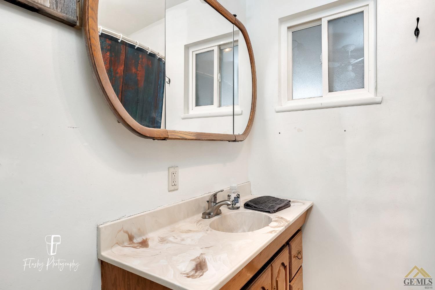 Undisclosed Address Bakersfield, CA 93304 - Photo 19 of 38 a bathroom with a sink a mirror and vanity