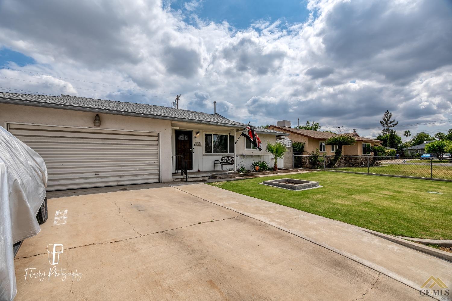 Undisclosed Address Bakersfield, CA 93304 - Photo 2 of 38 a front view of a house with a yard