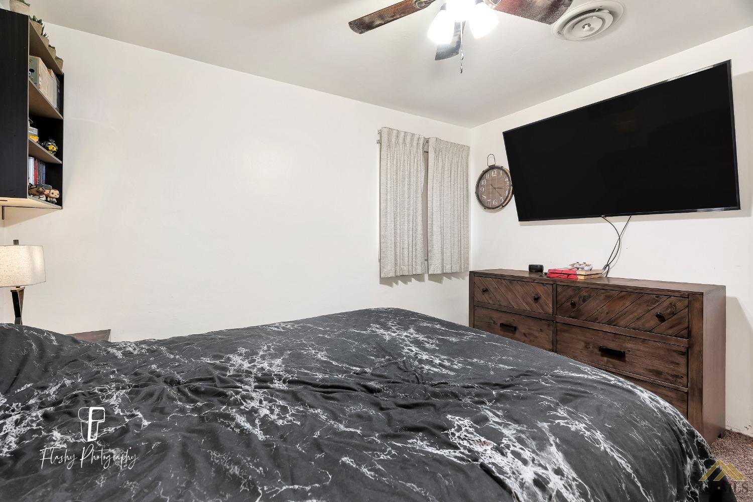 Undisclosed Address Bakersfield, CA 93304 - Photo 21 of 38 a bedroom with a bed and a flat screen tv