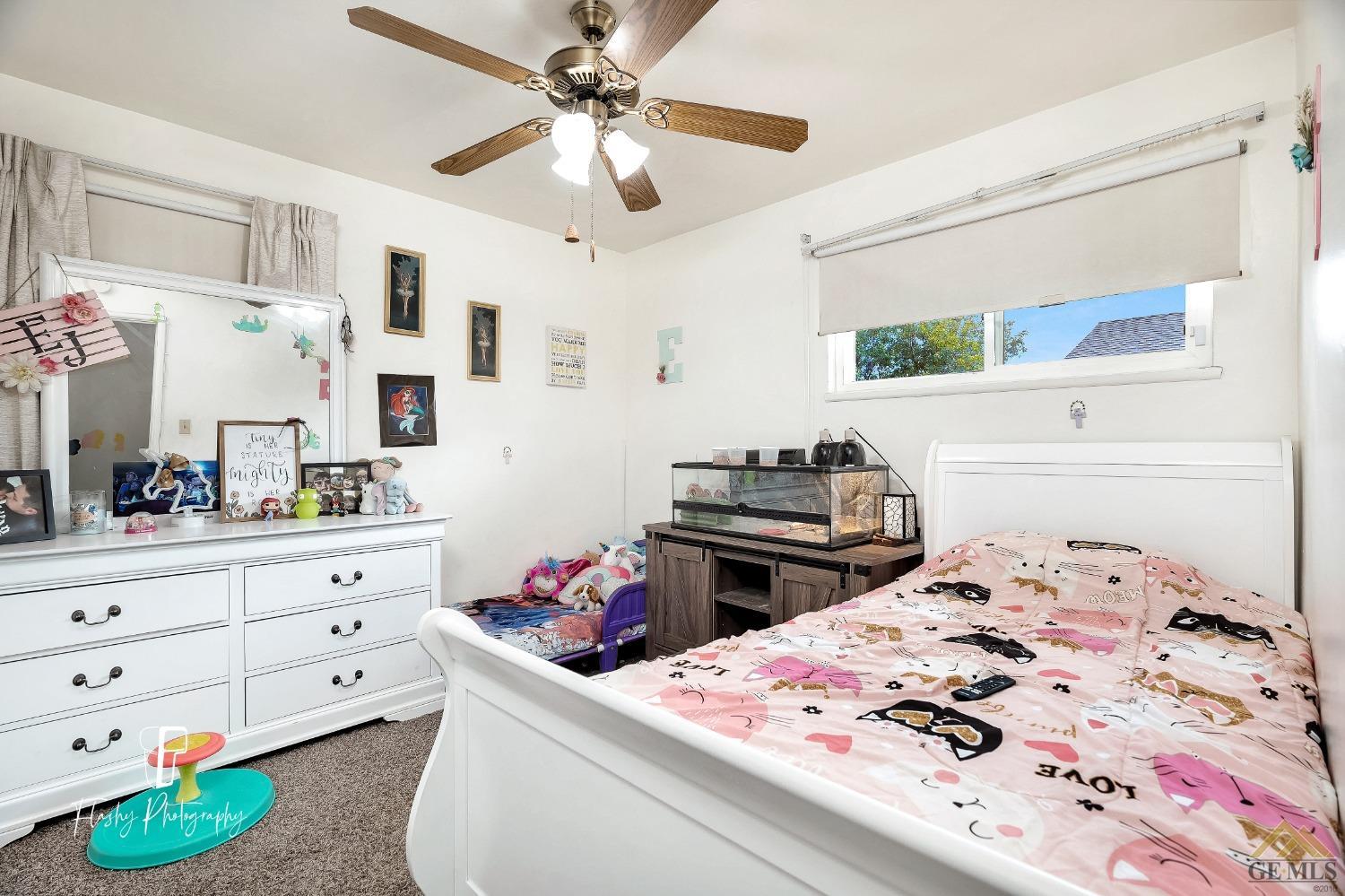 Undisclosed Address Bakersfield, CA 93304 - Photo 22 of 38 a bedroom with a bed and a dresser in it