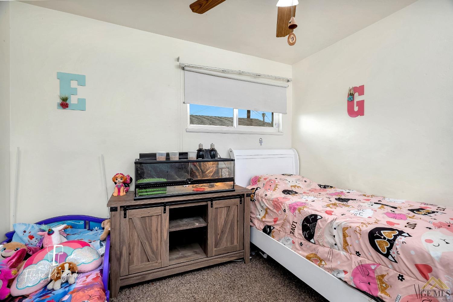 Undisclosed Address Bakersfield, CA 93304 - Photo 23 of 38 a bedroom with a bed and a dresser in it