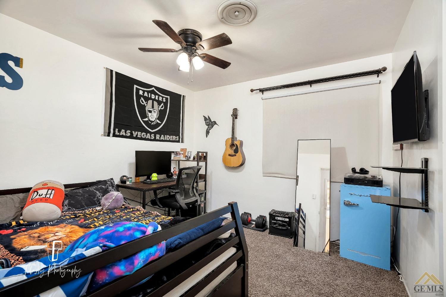 Undisclosed Address Bakersfield, CA 93304 - Photo 24 of 38 a bedroom with furniture and a flat screen tv