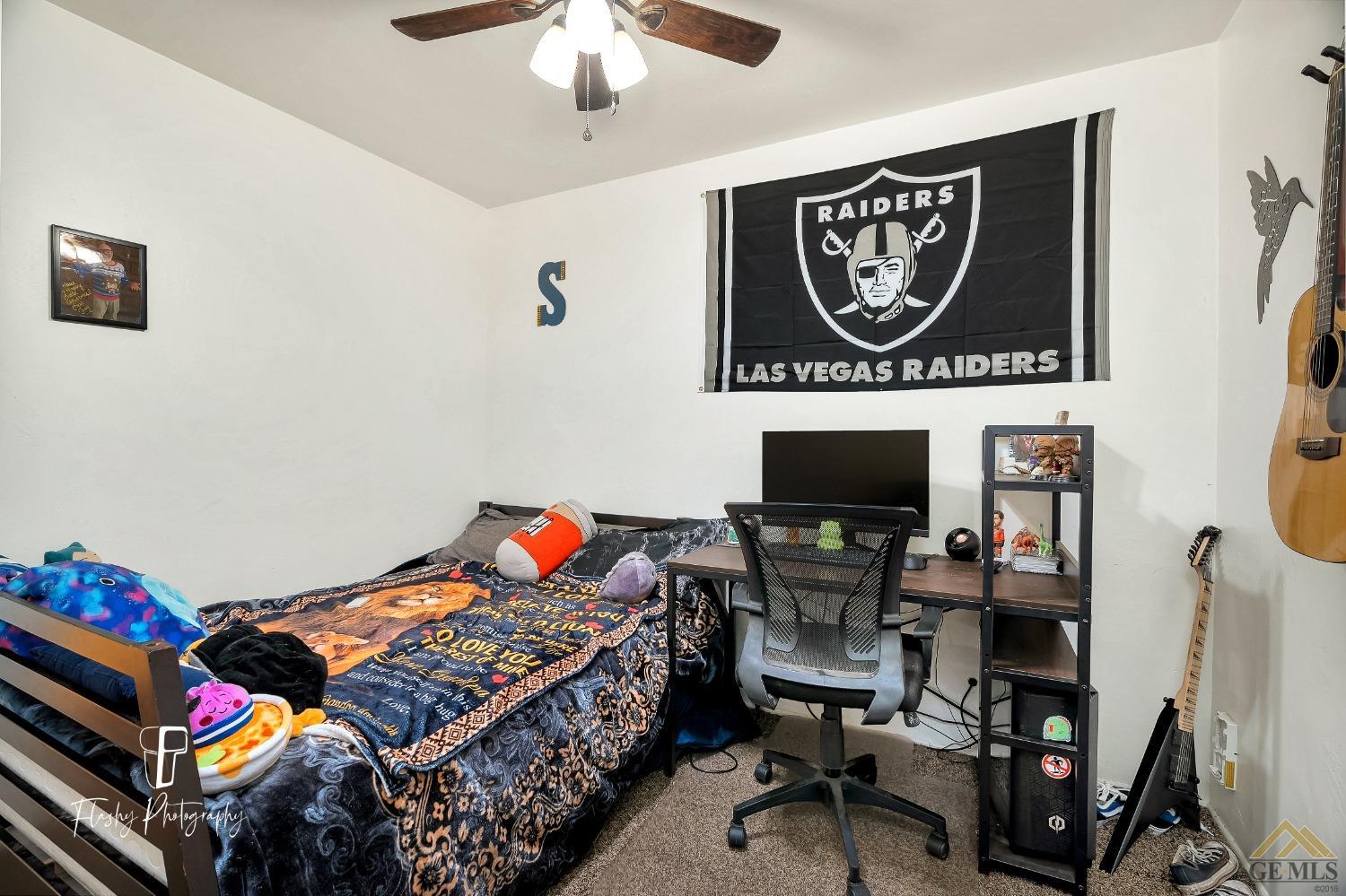 Undisclosed Address Bakersfield, CA 93304 - Photo 25 of 38 a bedroom with bed and a chandelier