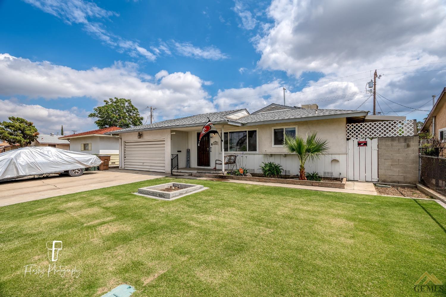 Undisclosed Address Bakersfield, CA 93304 - Photo 3 of 38 a front view of house with yard and trees in the background