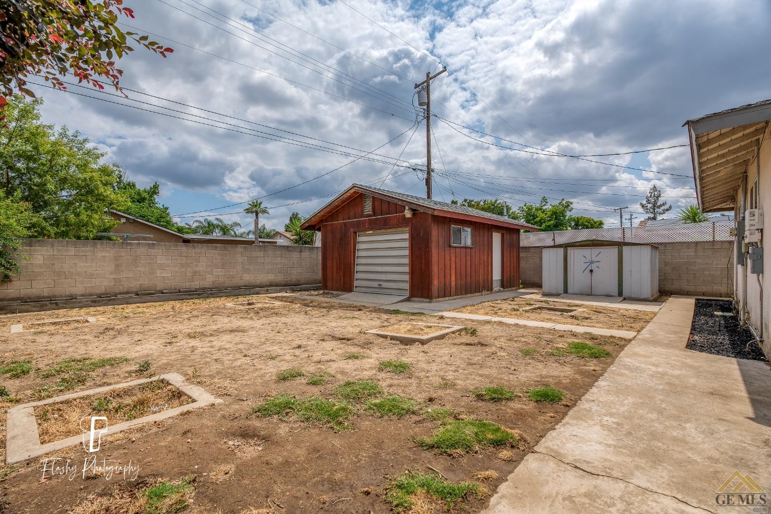 Undisclosed Address Bakersfield, CA 93304 - Photo 32 of 38 a front view of a house with a yard and garage