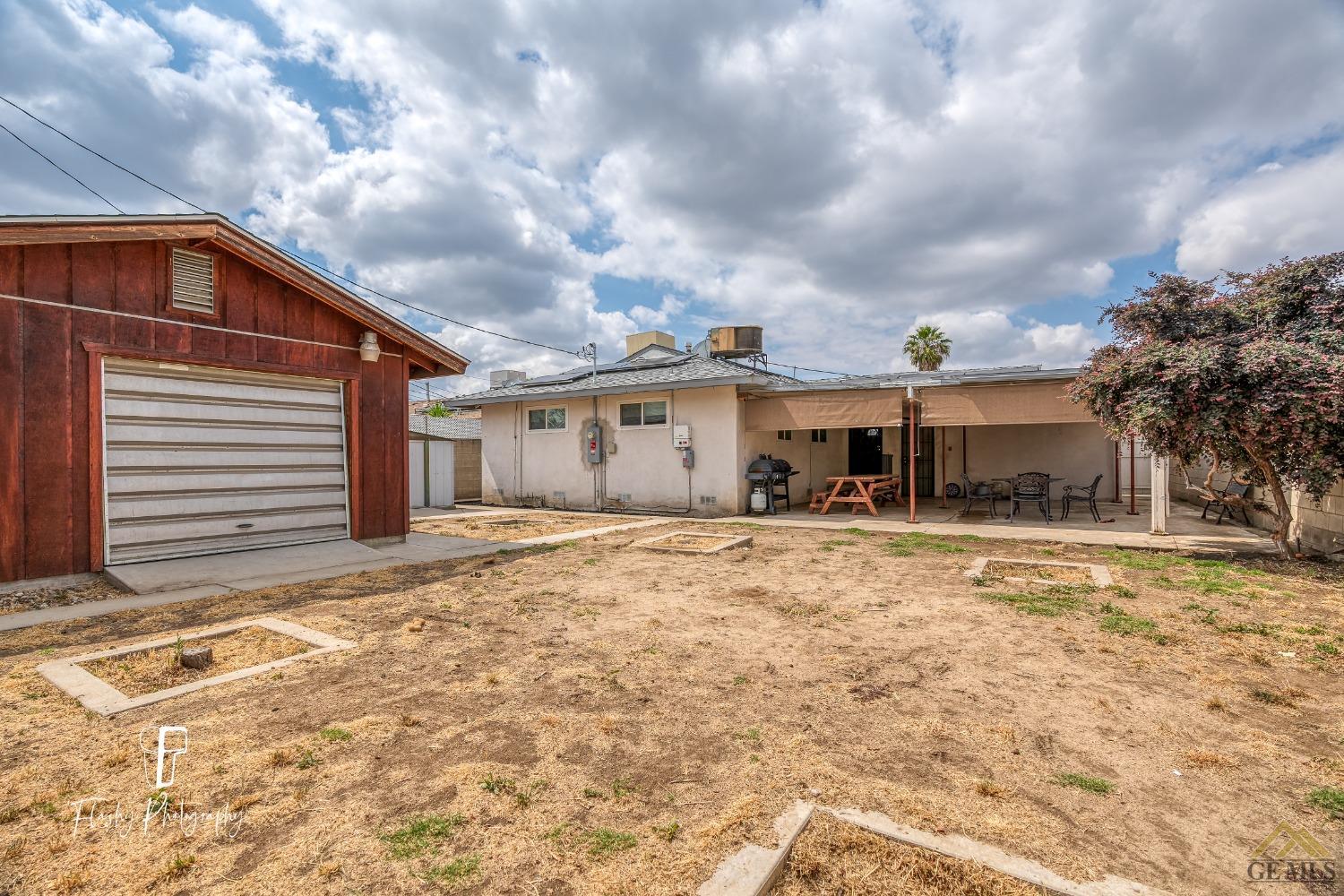 Undisclosed Address Bakersfield, CA 93304 - Photo 34 of 38 a view of a house with a yard and garage