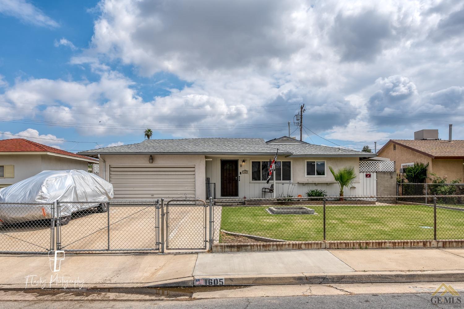 Undisclosed Address Bakersfield, CA 93304 - Photo 5 of 38 a front view of a house with garden