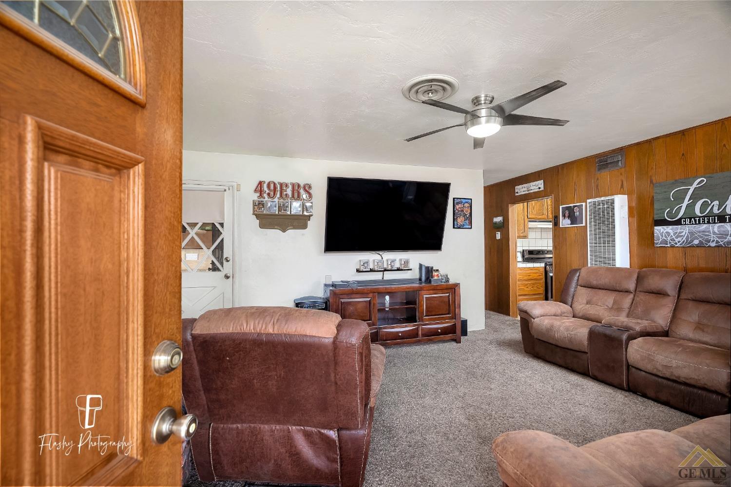 Undisclosed Address Bakersfield, CA 93304 - Photo 10 of 38 a living room with furniture and a flat screen tv