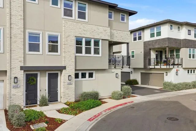 a front view of a house with yard and green space