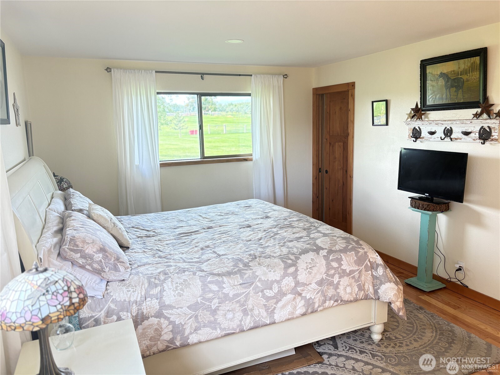 8 Mundinger Lane Omak, WA 98841 - Photo 15 of 37 a bedroom with a bed television on desk and a window