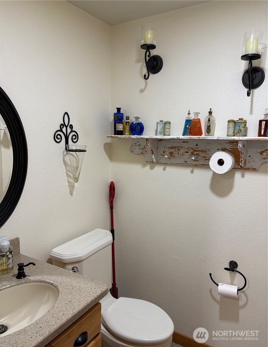 8 Mundinger Lane Omak, WA 98841 - Photo 20 of 37 a bathroom with a granite countertop toilet sink and mirror