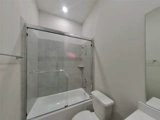 a bathroom with a shower and a toilet