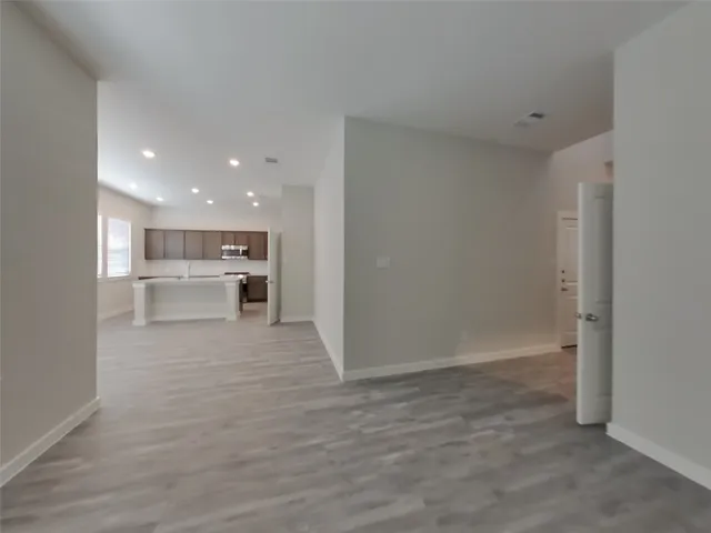 a view of a kitchen with a sink and a refrigerator