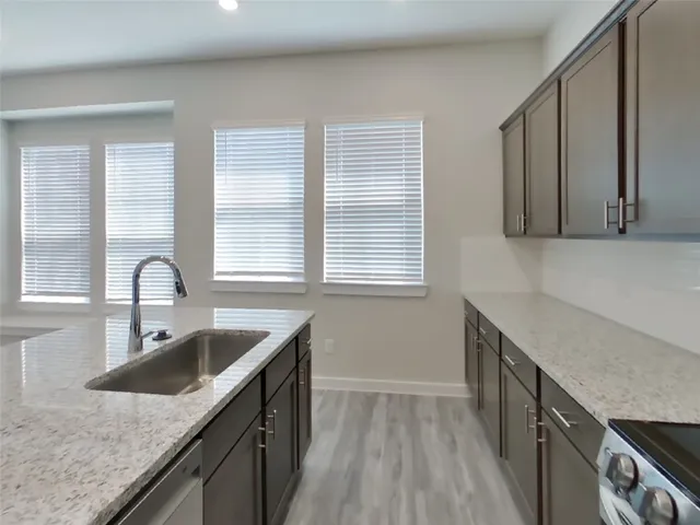 a kitchen with a sink stove and cabinets