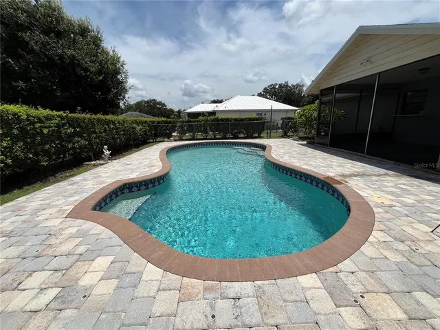 a view of a swimming pool with a yard