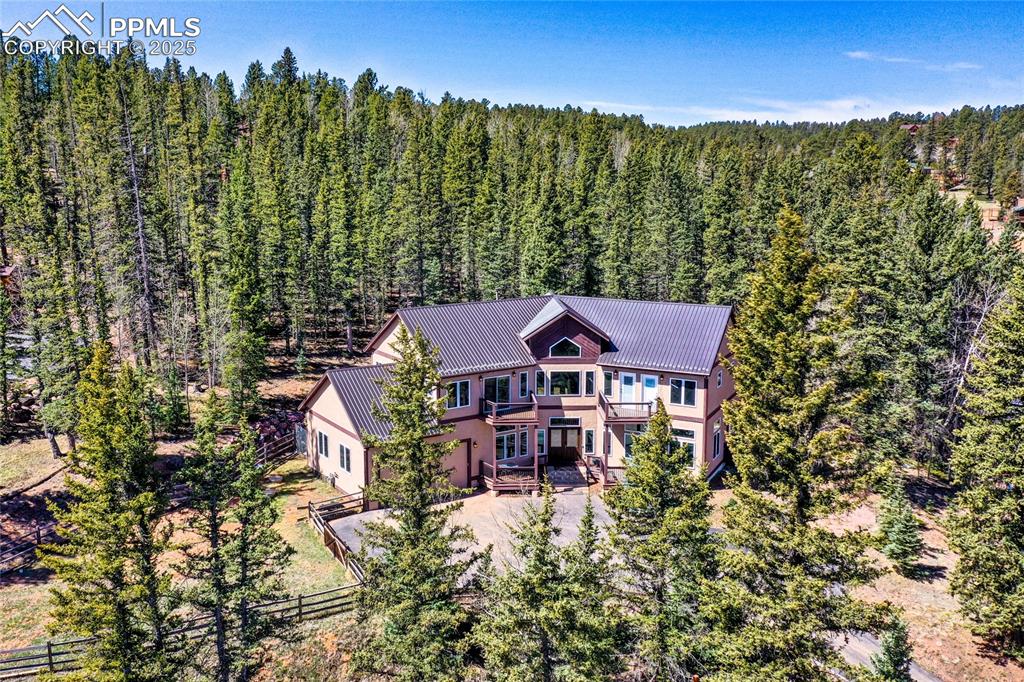 a view of a house with a yard and sitting area